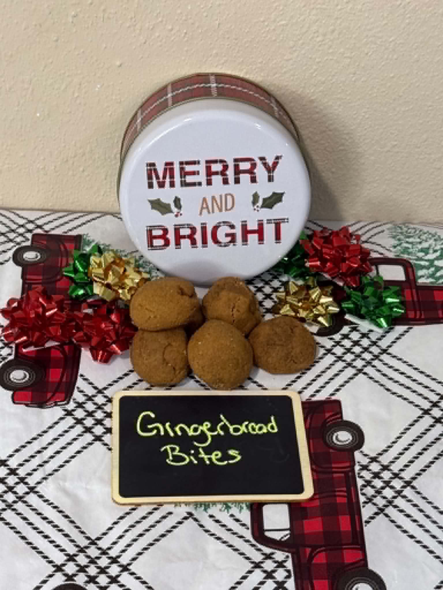 Gingerbread bites styled with a Merry and Bright holiday tin and gift bows