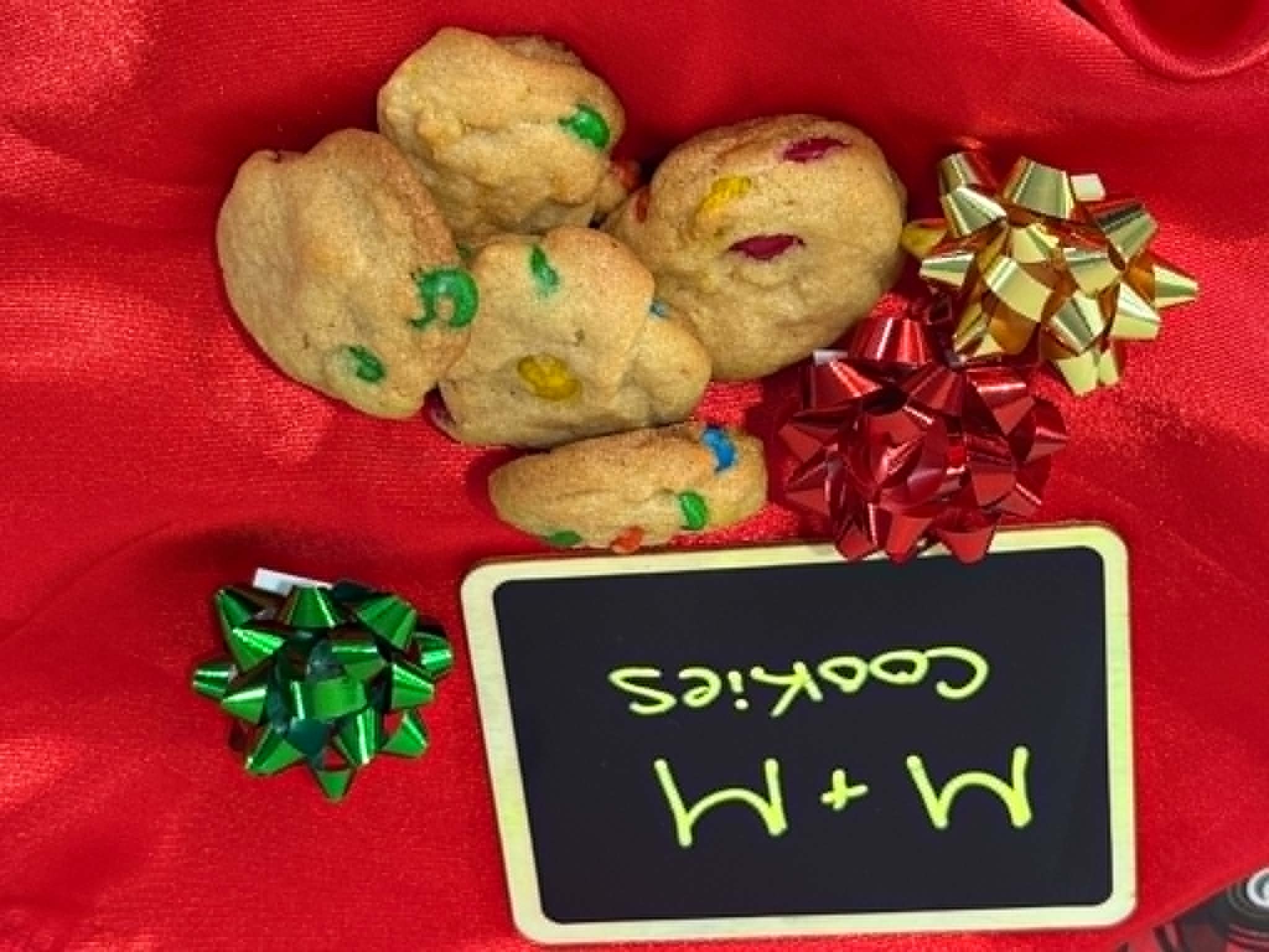 Mini M&M cookies on a red holiday backdrop