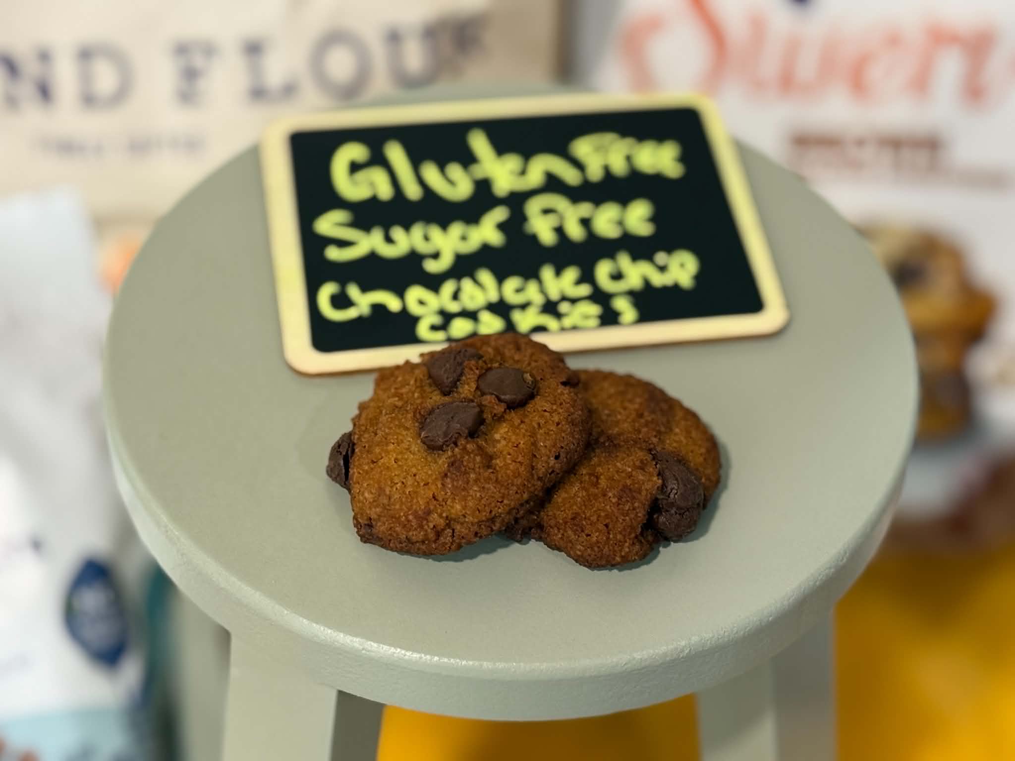 Gluten-free sugar-free chocolate chip cookies on a sage stool