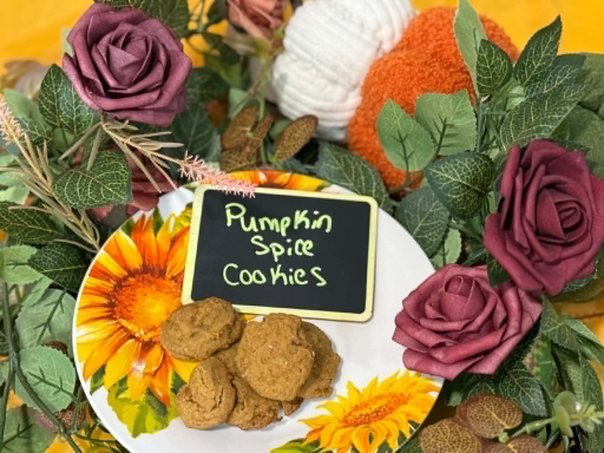 Soft pumpkin spice cookies styled with sunflowers, roses, and a velvet pumpkin
