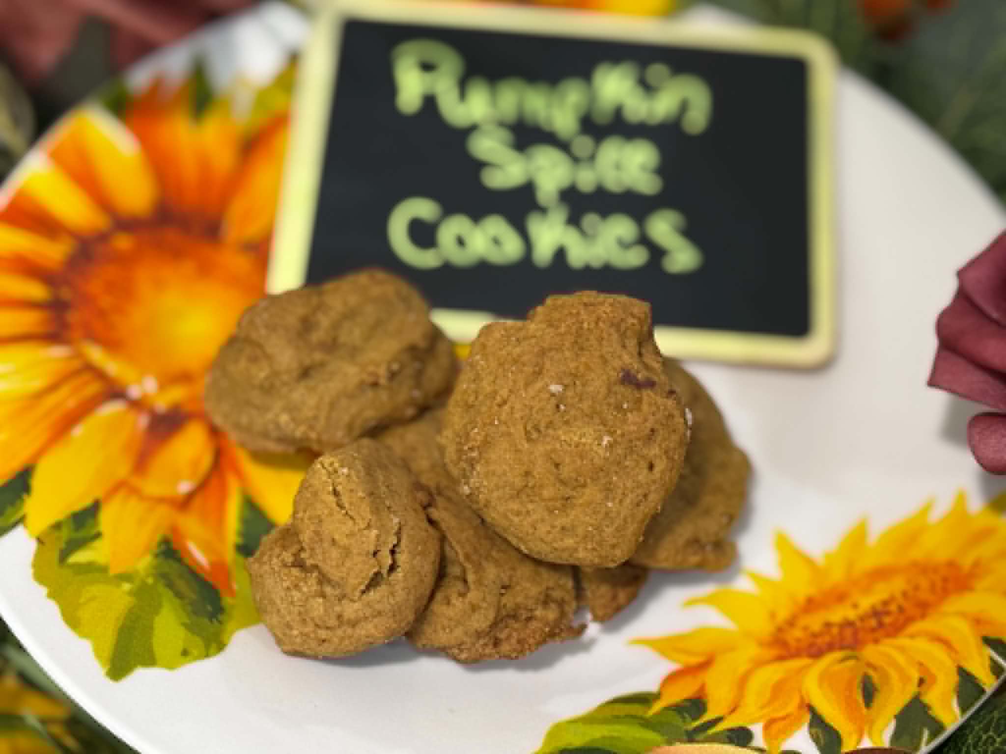 Close-up of fresh pumpkin spice cookies with a chalkboard sign