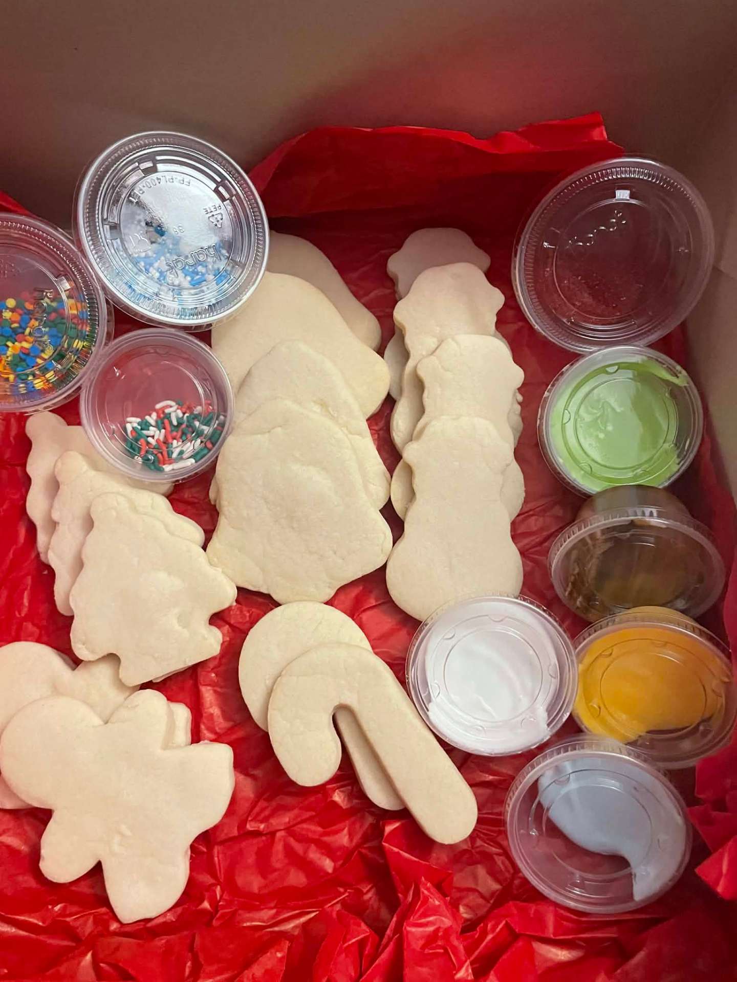 Holiday sugar cookie shapes with frosting cups, ready to decorate